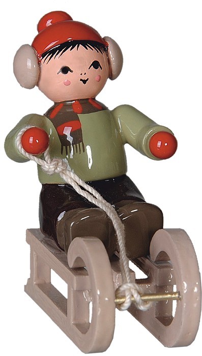 Winterkind Junge auf Schlitten Winterkind Junge auf Schlitten
