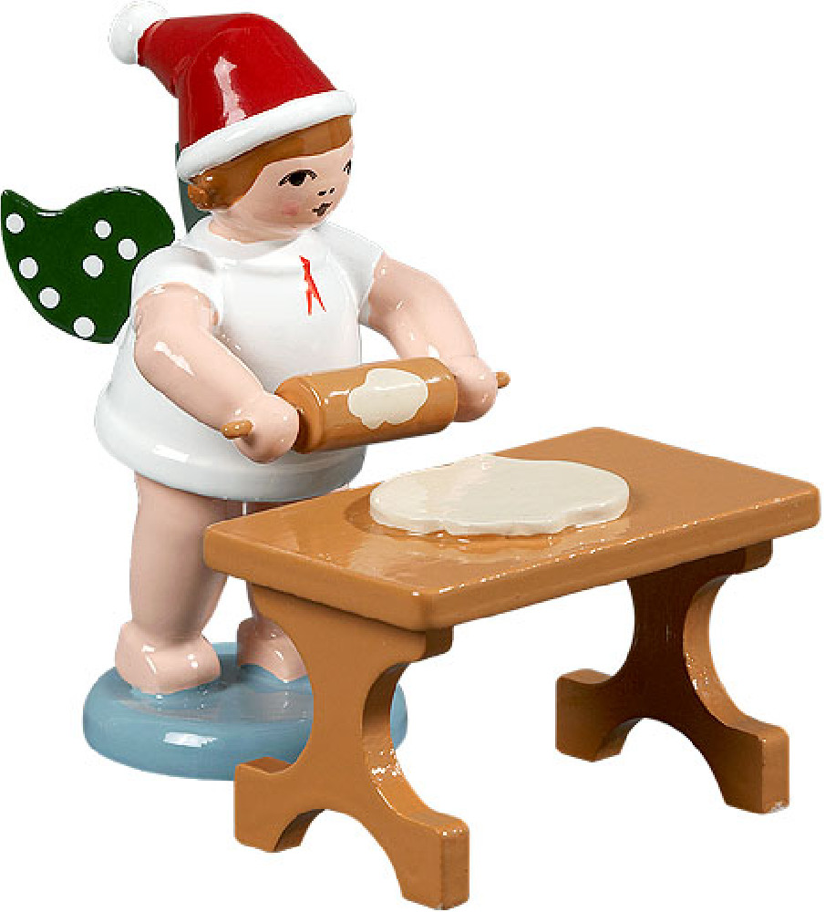 Weihnachtsengel mit Teigrolle am Tisch, mit Mütze